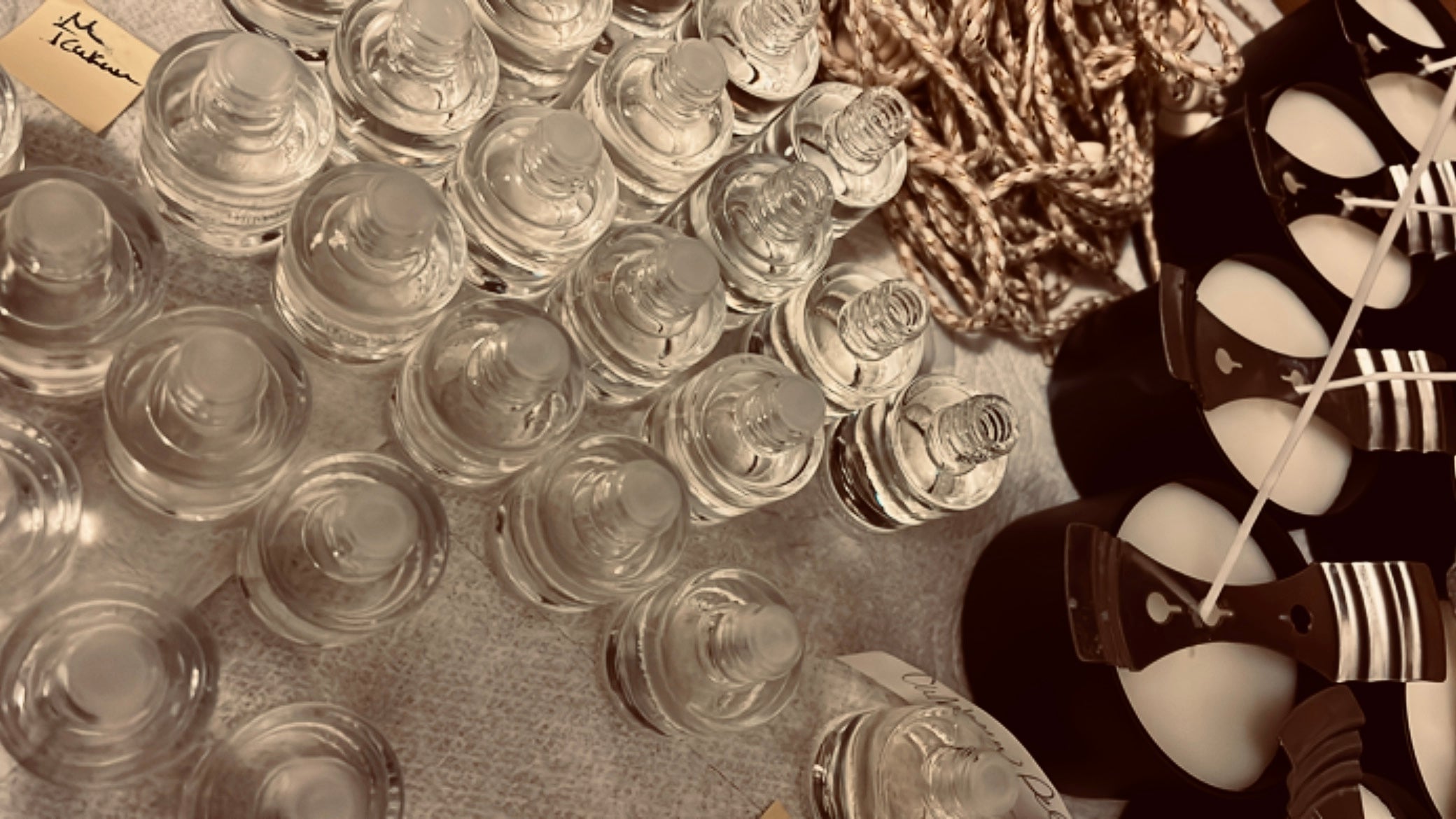 clear bottles and dark candle tins