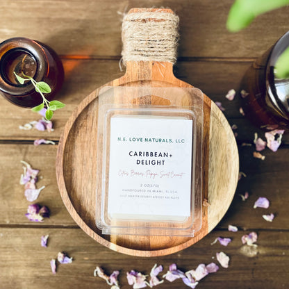 Wax Melt labeled 'Caribbean Delight' by N.E. Love Naturals on a wooden tray with decorative elements.